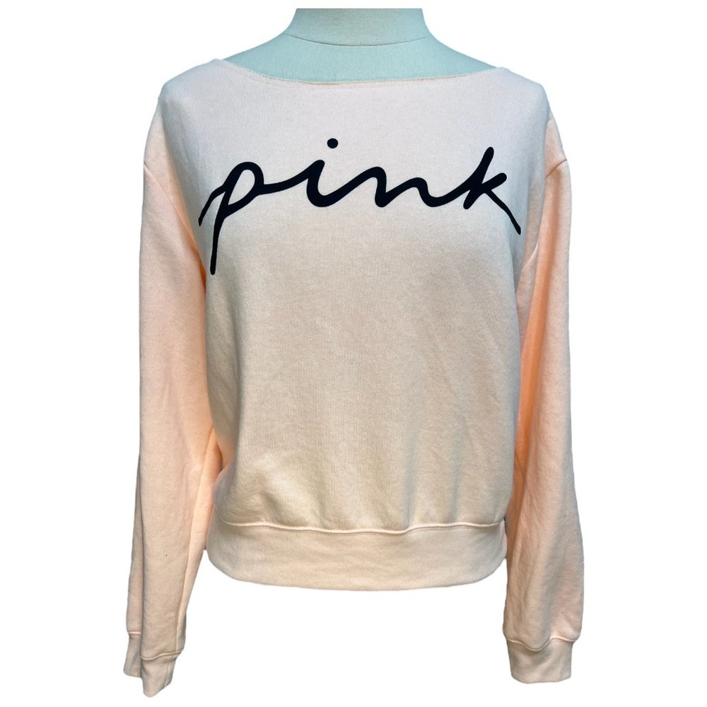 Bright peach cropped sweatshirt.